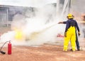 Volunteer using fire extinguisher from hose for fire fighting during basic fire fighting training evacuation