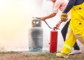 Volunteer using fire extinguisher from hose for fire fighting during basic fire fighting training Royalty Free Stock Photo