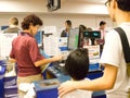 Volunteer with visitors at Cashier counter.