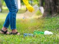 Volunteer women collect plastic water bottles in the park area, From people who refuse to throw in the trash