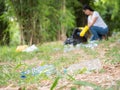 Volunteer women collect plastic water bottles in the park area Royalty Free Stock Photo