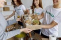 Volunteer work. Young activists giving food in carton boxes as donation for poor and elderly people, closeup Royalty Free Stock Photo