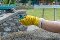 volunteer worker painting with brush or roller and renovate railing or fence Royalty Free Stock Photo