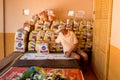 A volunteer working wearing a protective mask as he counts bags of food to be given away to the poor