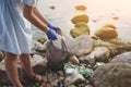 Volunteer young woman collecting garbage, holding full bag of waste and plastic bag Royalty Free Stock Photo