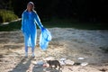 volunteering, charity, cleaning, people and ecology concept, volunteer with garbage bag cleaning area on the beach Royalty Free Stock Photo