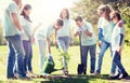 Group of volunteers planting and watering tree Royalty Free Stock Photo