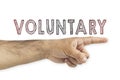 Volunteering concept. Hand pointing to voluntary inscription on white