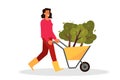 Volunteering woman holding a cart with tree.