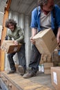 Volunteers from BookCycle stack boxes inside the container