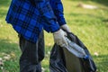 Volunteers collect plastic bottles in garbage bags ecology natural pollution garbage care charity volunteer community environment Royalty Free Stock Photo