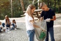 Children collects garbage in garbage bags in park