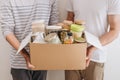 Volunteers with donation box with foodstuffs