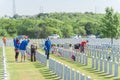 Volunteers and family members place flags on fallen heroes heads