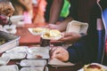 Volunteers giving food to poor people: The concept of food sharing Help solve Hunger for the homeless Royalty Free Stock Photo