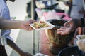 Volunteers giving food to poor people in desperate need : The concept of food sharing Help solve Hunger for the homeless