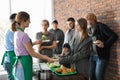 Volunteers giving food to poor people