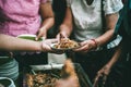 Volunteers are giving free food to help the hungry poor : concept of food sharing