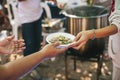 Volunteers are giving free food to help the hungry poor : concept of food sharing