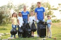 Volunteers with kids collecting trash