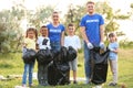 Volunteers with kids collecting trash