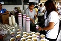 Volunteers of an a non profit organization serve food to the public during a weekly feeding program