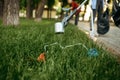 Volunteers picking trash from the grass in park