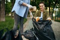 Volunteers picking trash in park, volunteering