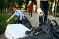 Volunteers picking trash in park, volunteering