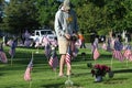 Volunteers placing an American Flag on the grave of a Military Veteran for Memorial Day