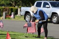 Volunteers placing an American Flag on the grave of a Military Veteran for Memorial Day