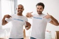 Volunteers pointing at signs on t-shirts