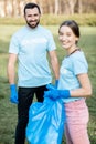 Volunteers portrait with rubbish bags in the park