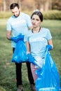 Volunteers portrait with rubbish bags in the park