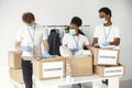 Volunteers in protective masks and gloves pack boxes