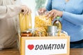 Volunteers putting various dry food in donation box for help people Royalty Free Stock Photo