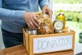 Volunteers putting various dry food in donation box for help people Royalty Free Stock Photo