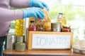 Volunteers putting various dry food in donation box for help people Royalty Free Stock Photo