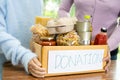 Volunteers putting various dry food in donation box for help people Royalty Free Stock Photo