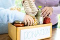 Volunteers putting various dry food in donation box for help people Royalty Free Stock Photo