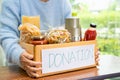 Volunteers putting various dry food in donation box for help people Royalty Free Stock Photo