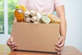 Volunteers putting various dry food in donation box for help people Royalty Free Stock Photo