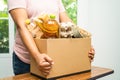 Volunteers putting various dry food in donation box for help people Royalty Free Stock Photo