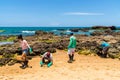 Volunteers remove black oil from the Rio Vermelho beach spilled by a ship in the Brazilian sea