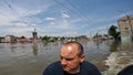 Volunteers sail on boat to evacuate animals and people after detonation of Hydroelectric Power Station. Flooding in