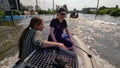 Volunteers sail on boat to evacuate animals and people after detonation of Hydroelectric Power Station. Flooding in