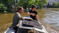 Volunteers sail on boat to evacuate animals and people after detonation of Hydroelectric Power Station. Flooding in