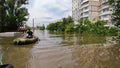 Volunteers sail on boat to evacuate animals and people after detonation of Hydroelectric Power Station. Flooding in