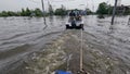 Volunteers sail on boat to evacuate animals and people after detonation of Hydroelectric Power Station. Flooding in