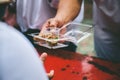 Volunteers serving food for poor people : concept of free food serving Royalty Free Stock Photo